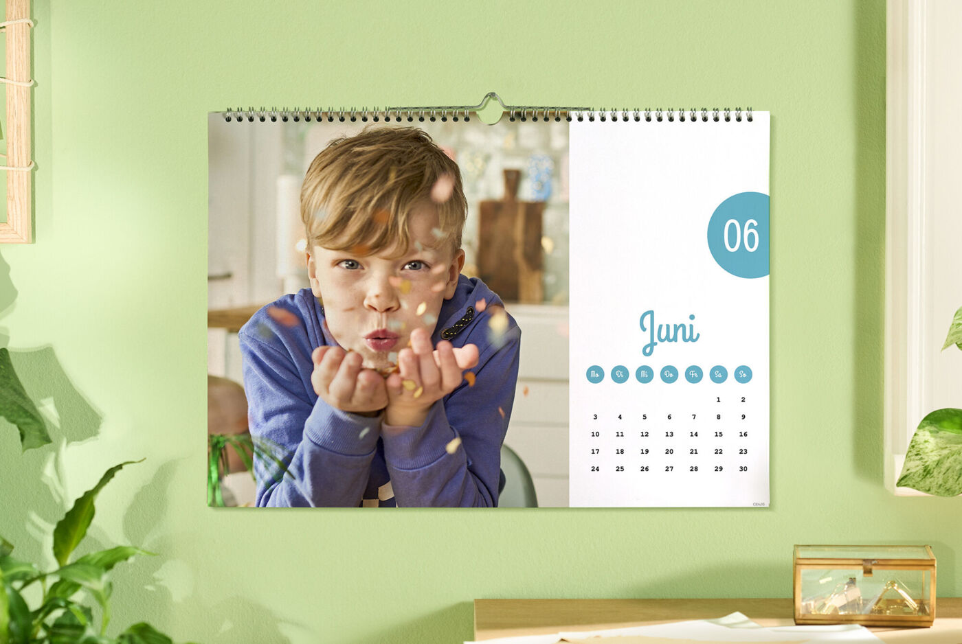 Ein Kalender mit einem Foto eines Kindes, das die Hände voller Konfetti hält