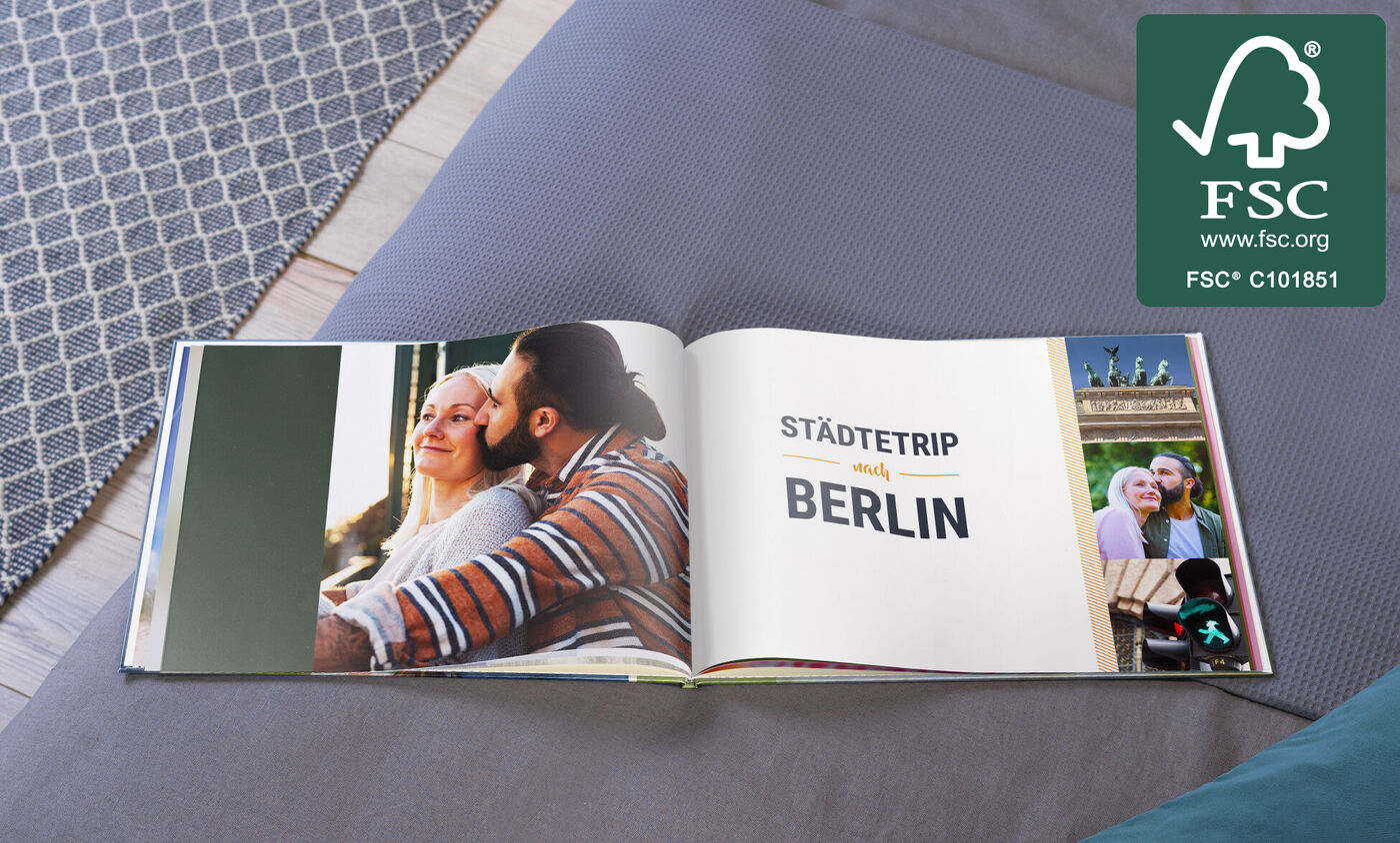Offenes Fotobuch auf einem Tisch mit Reiseerinnerungen aus Berlin